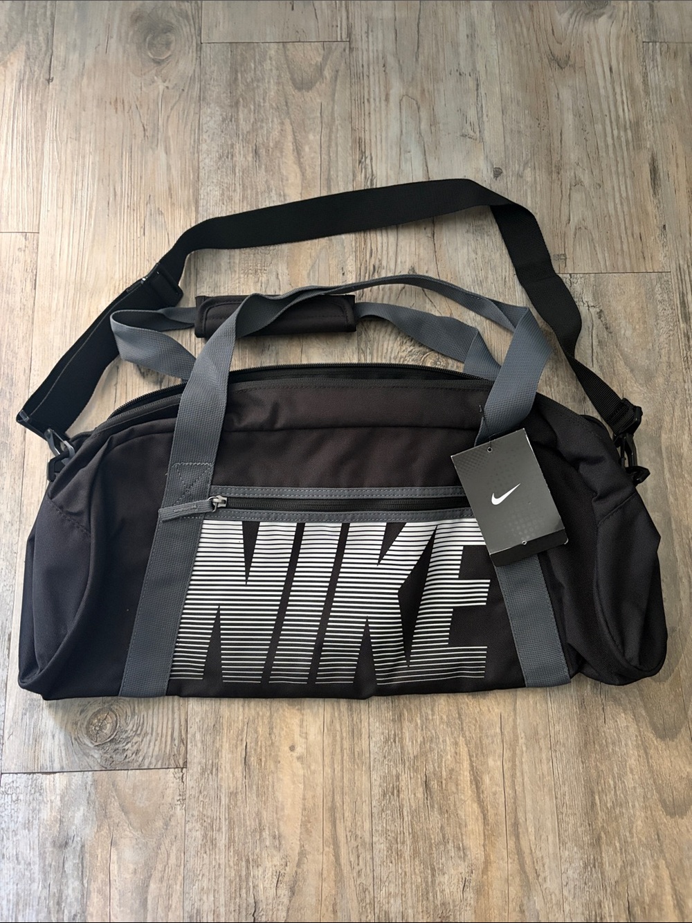 Nike Black Duffel Bag with Gray Straps and White Logo